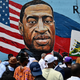 People gather at the unveiling of artist Kenny Altidor’s memorial portrait of George Floyd painted on a storefront sidewall of CTown Supermarket on July 13, 2020 in Brooklyn, New York.